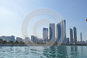 Abu Dhabi city skyline along Corniche beach taken from a boat