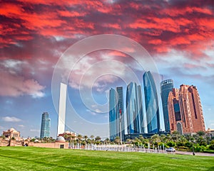 Abu Dhabi modern skyline from Emirates Palace Gardens on a sunny