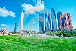 Abu Dhabi modern skyline from Emirates Palace Gardens on a sunny