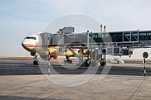Abu Dhabi . November 2012. Airplane is on the platform at the glass jet bridge at the Abu Dhabi airport. Preparation for flight