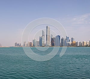 The Abu Dhabi skyline of skyscrapers in the United Arab Emirates, at the Persian Arabian Gulf coast. On the Arabian Peninsula ci