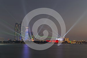 Abu Dhabi skyline at sunset with Emirates Palace lit up for the National day