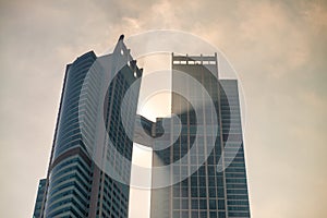 ABU DHABI, UAE - DECEMBER 7, 2016: Modern city skyscrapers backlit with sun rays