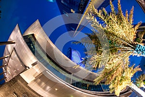 ABU DHABI, UAE - DECEMBER 8, 2016: Skyward wide angle night view of skyscrapers along Corniche Road