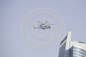 Abu Dhabi. UAE - march 18, 2024: Helicopter flying over skyscrapers in the city of Abu Dhabi