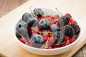 Abundance of berries in a white bowl/ abundance of berries in a