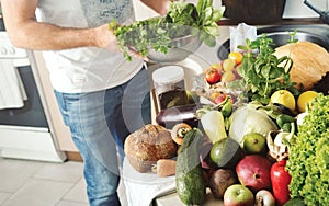 Abundance fruits and vegetables on wooden table in home kitchen