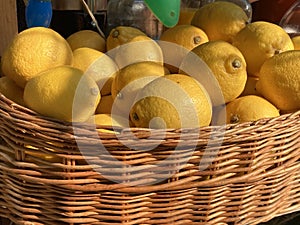 An abundance of lemons in a wicker basket