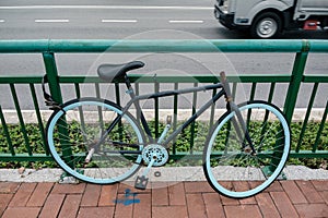 Abundant bicycle parked and locked on fence