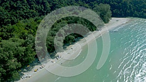 Abundant nature of white beach and forest all around the mountain in the open sky day by angle view from top view drone.