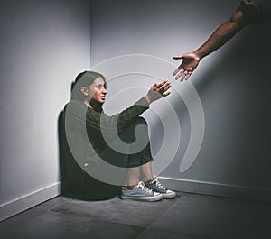 Abuse, scared and woman with a hand of a person in a dark room for depression and mental health help. Horror, stress and