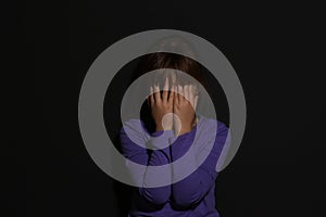 Abused little girl crying near wall. Domestic violence concept