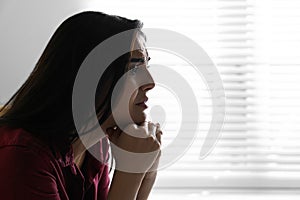 Abused young woman crying, space for text. Domestic violence concept