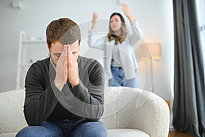 Abusive wife arguing husband, jealous distrustful dominant woman shouting at sad man