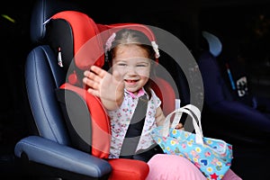 Aby girl sitting in a child car seat