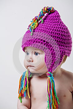 Aby on white background with pink wool hat and colored fringes