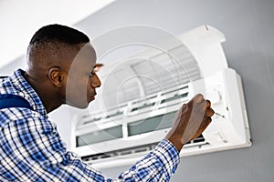 AC Electrician Technician Repairing Air Conditioner
