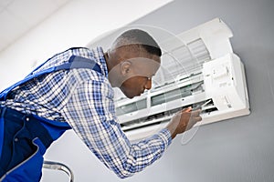 AC Electrician Technician Repairing Air Conditioner