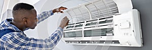 AC Electrician Technician Repairing Air Conditioner photo