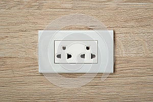 AC power plugs and sockets in wooden wall