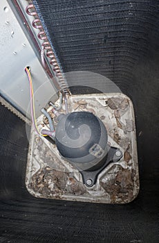 AC unit dusty and dirty with old leaves AC, view from inside. Maintenance of air conditioner system unit