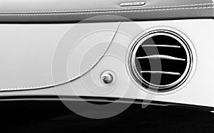 AC Ventilation Deck Luxury Car Interior. Modern car interior details white leather, natural wood. Black and white