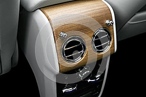 AC Ventilation Deck in Luxury modern car Interior. Modern car white leather interior. with stitching. Natural wood. Perforated lea