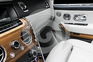 AC Ventilation Deck in Luxury modern car Interior. Modern car white leather interior. with stitching. Natural wood. Perforated lea