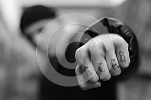 ACAB tattoo on the arm of a bully man. Black and white photo