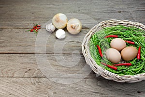 Acacia pennata and egg in basket on wood background
