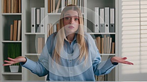 Academic student girl in library shrug unsure don't know Caucasian woman shrugging shoulders hesitation shows