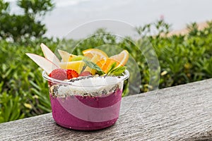 Acai bowl takeaway with fresh fruit and mint photo