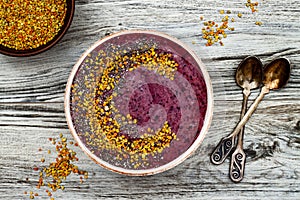 Acai breakfast superfoods smoothies bowl with chia seeds, bee pollen toppings. Immune boosting, anti inflammatory smoothie