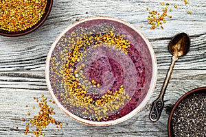 Acai breakfast superfoods smoothies bowl with chia seeds, bee pollen toppings. Immune boosting, anti inflammatory smoothie