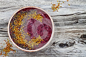 Acai breakfast superfoods smoothies bowl with chia seeds, bee pollen toppings. Immune boosting, anti inflammatory smoothie