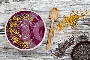 Acai breakfast superfoods smoothies bowl with chia seeds, bee pollen toppings. Immune boosting, anti inflammatory smoothie