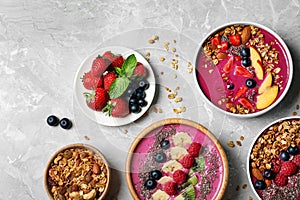 Acai smoothie bowls with granola and berries on table, flat lay