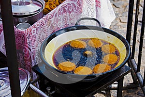 AcarajÃ© being fried in dende oil pan. AcarajÃ© is a gastronomic specialty of African and Afro-Brazilian cuisine