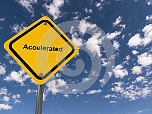 accelerated traffic sign on blue sky photo