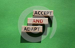 Accept or adapt symbol. Wooden blocks with words Accept and adapt. Beautiful green background. Business and Accept and adapt