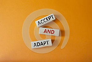 Accept or adapt symbol. Wooden blocks with words Accept and adapt. Beautiful orange background. Business and Accept and adapt