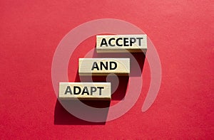 Accept or adapt symbol. Wooden blocks with words Accept and adapt. Beautiful red background. Business and Accept and adapt concept