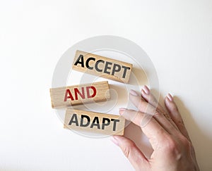 Accept or adapt symbol. Wooden blocks with words Accept and adapt. Beautiful white background. Businessman hand. Business and
