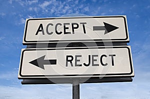 White two street signs with arrow on metal pole with word accept and reject photo