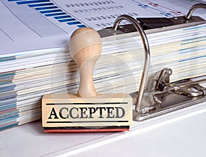 Accepted stamp with binder in the office
