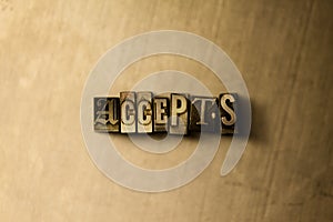 ACCEPTS - close-up of grungy vintage typeset word on metal backdrop photo