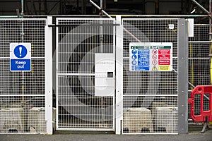 Access gate to construction site and health and safety message rules sign board signage