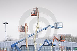 Access platform equipment powered high in sky in blue orange and yellow for high working platform height safety at construction bu