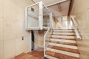 Access portal to a residential building with stairs and tiled floors nd an