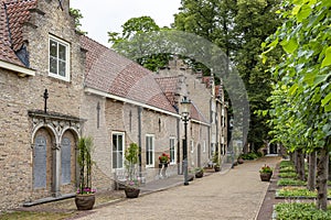 The access road with beautiful stylish outbuildings and old trees of Bouvigne Castle at Breda, Netherlands